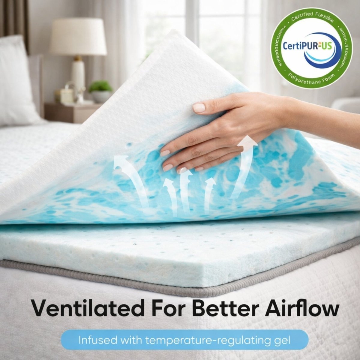 Close up of hand lifting the Kouvr memory foam topper revealing ventilation holes and CertiPUR-US certification badge for breathable airflow.