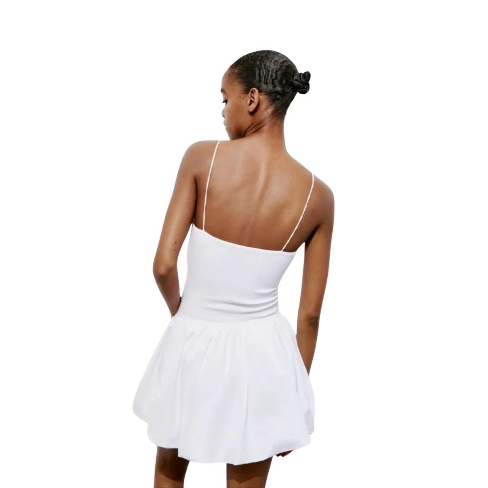 Model wearing the Kouvr white bubble hem mini dress with spaghetti straps