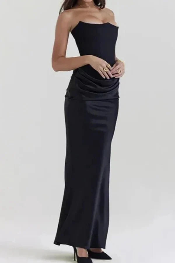 Full-length side view of a model in the Kouvr Zanayah black satin strapless maxi dress.