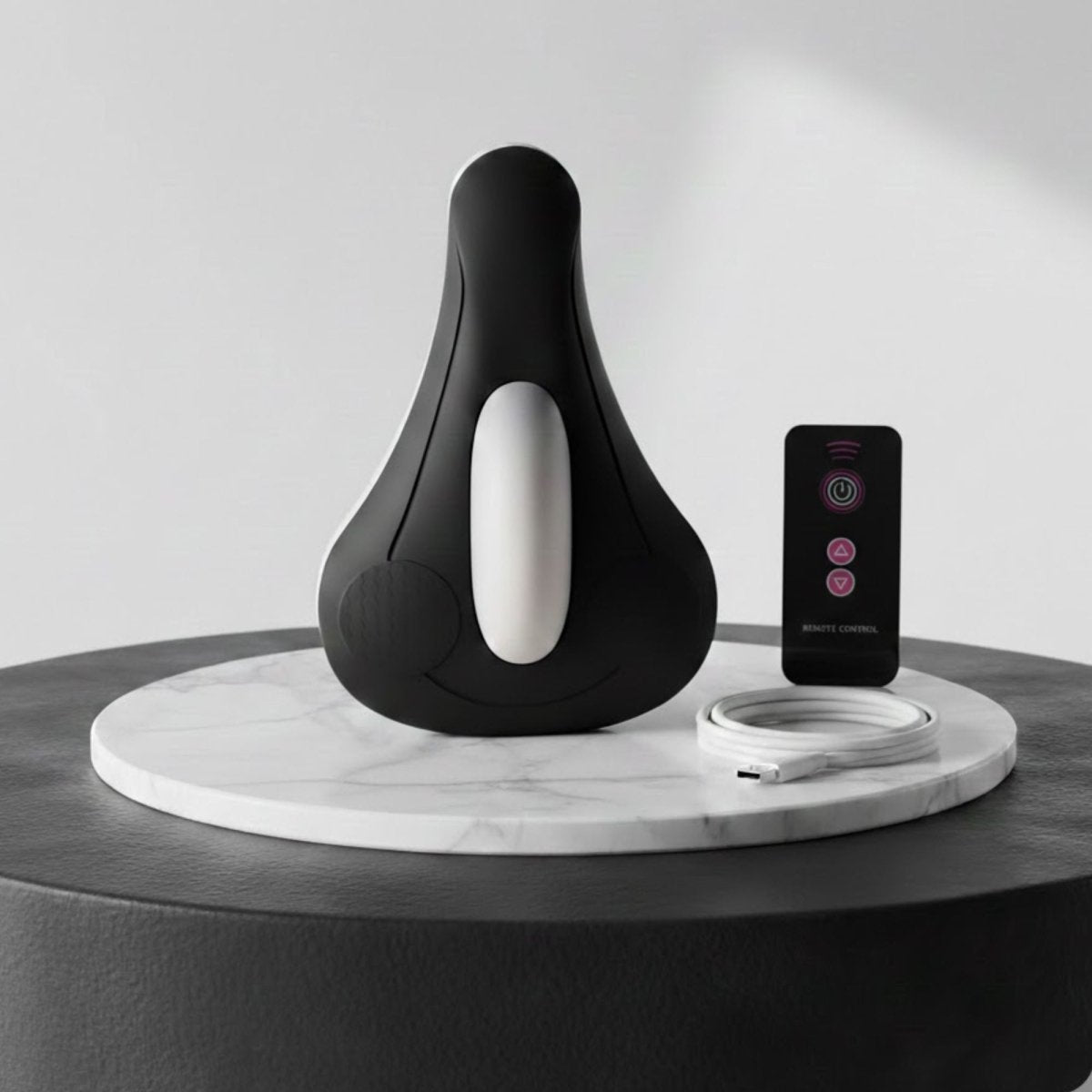 Complete Kouvr pelvic floor toning kit including black device, wireless remote, and USB-C charger.