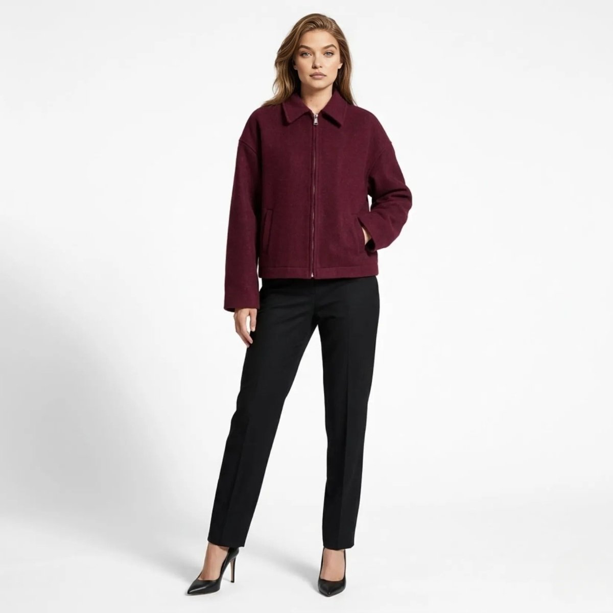 Woman wearing Kouvr wine wool blend cropped zip up jacket with black trousers front view